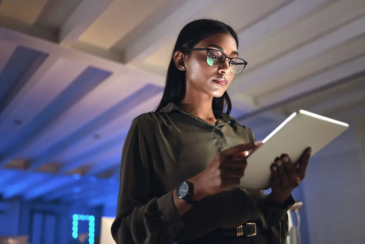 business woman with tablet looking at data